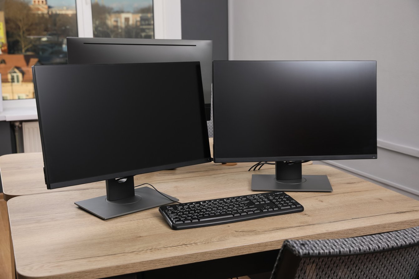 Modern Interior. Workplace with Multi-Monitor on Wooden Desk in